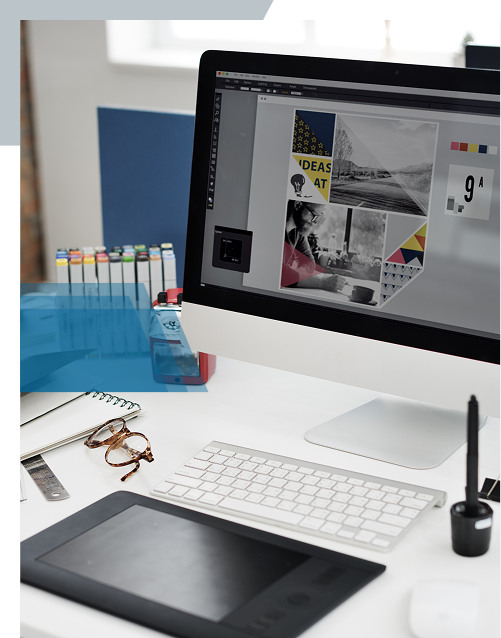 Designer's workspace with computer monitor and drawing tablet
