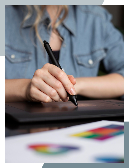 Designer working on a graphics tablet with colour swatches