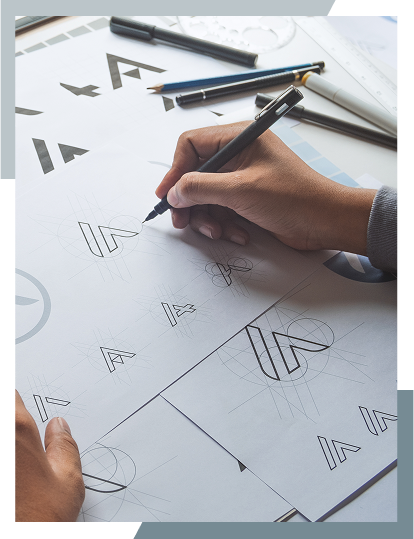 Designer sketching brand logo concepts on paper