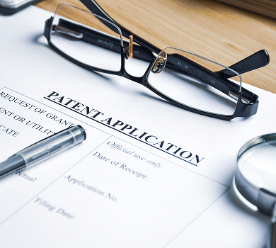 Patent application form with reading glasses and pen