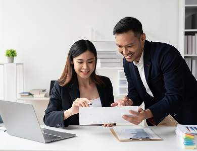 IP consultants reviewing documents together at a laptop