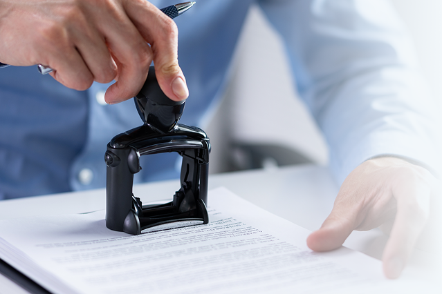 Hand stamping an official intellectual property document