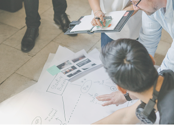 Professionals reviewing intellectual property documents at a table