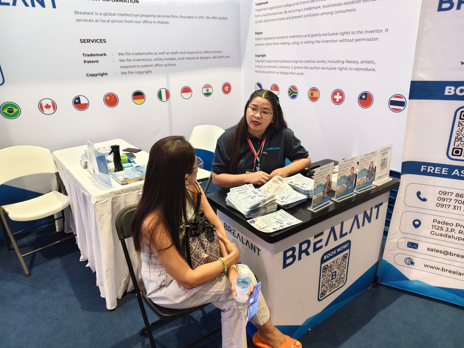 Brealant staff assisting visitors at the exhibition booth