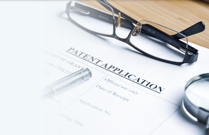 Patent application form with reading glasses and pen