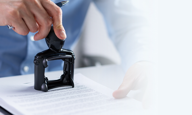 Hand stamping an official registered design document